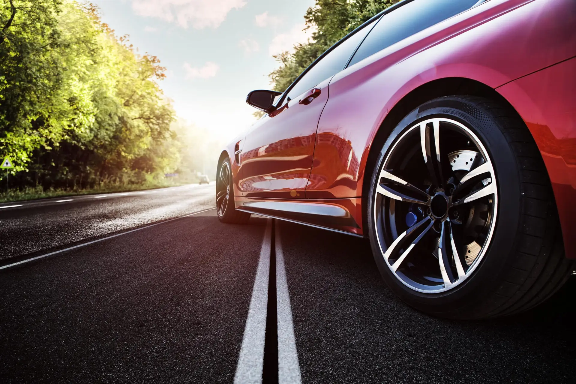 red sports car on the asphalt road